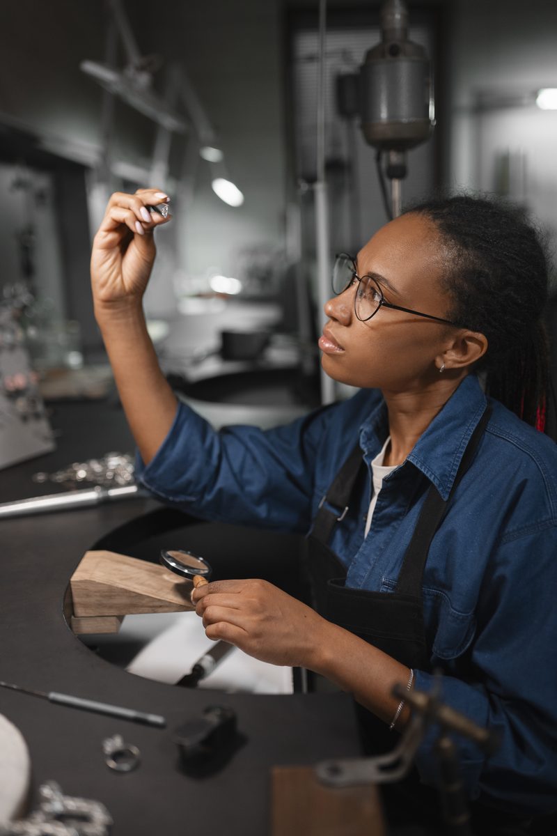 Technician inspecting precision work at a workshop bench